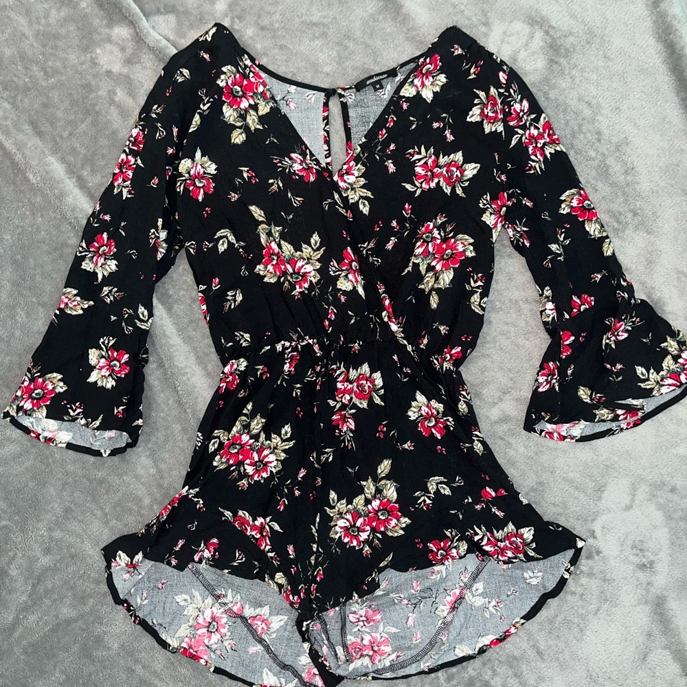 Black long sleeve floral romper.